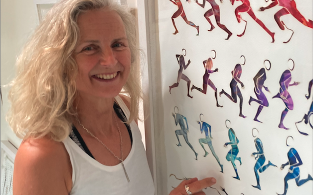 Annabel Eyres stands next to one of her pieces of Olympic art for 2024