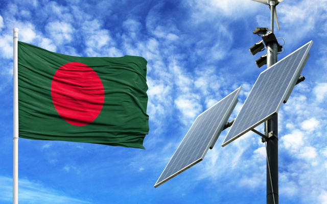 The Bangladeshi flag flies next to solar panels
