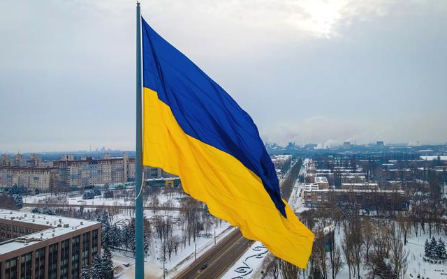 Ukrainian flag over snowy Kviv