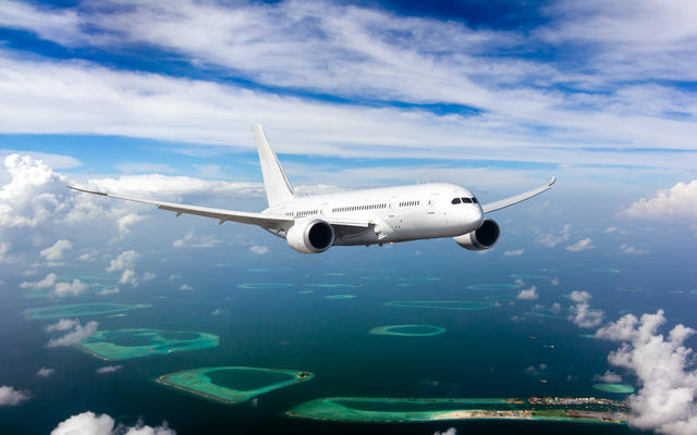 Unbranded whitebody Boeing Dreamliner air plane flying in the sky
