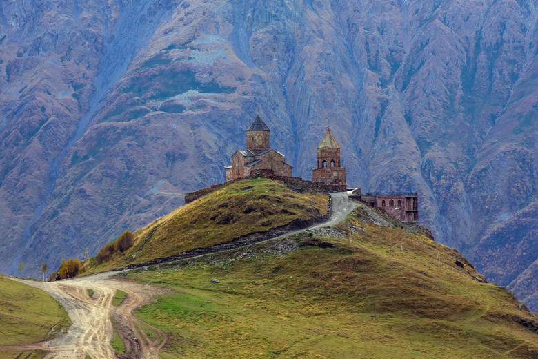 Tsminda Sameba Monastery, Kazbegi, Georgia, with mountains behind