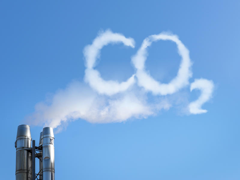 Smoke emission from a chimney that spells 'CO2'