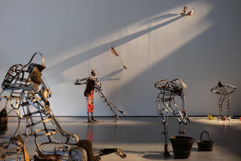 A room sun lit, full of strange metal fragments and sculptural elements