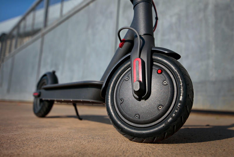 Close-up shot of an electric scooter front wheel 