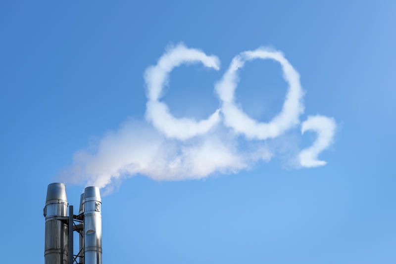 Smoke emission from a chimney that spells 'CO2'