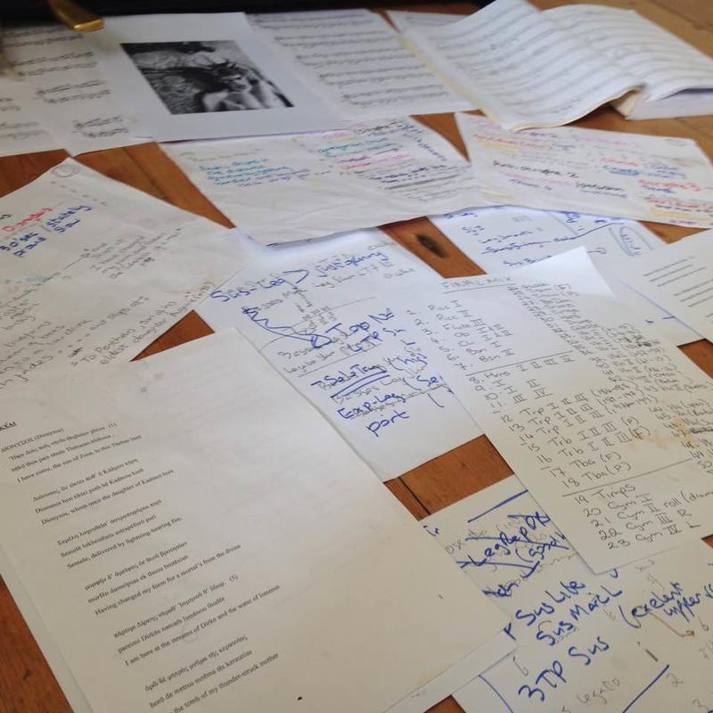 A table covered in pieces of paper with notes on musical production, composition ideas and lyrics