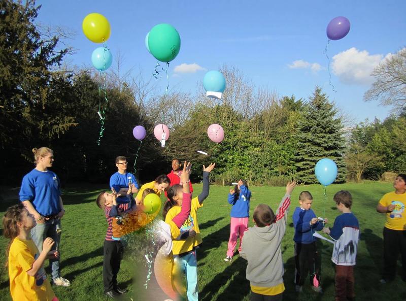 Children releasing balloons in to the air