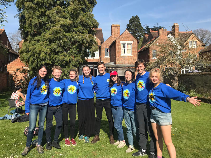 Nine Exeter College students in a group photo, all wearing ExVac sweatshirts