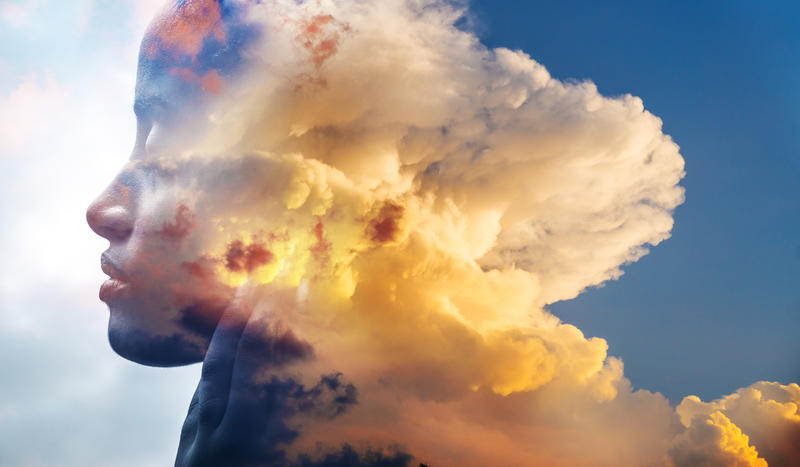 A manipulated image whereby a face merges into a cloud