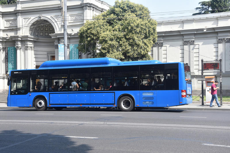 A gas-powered bus on a street in Tblisi