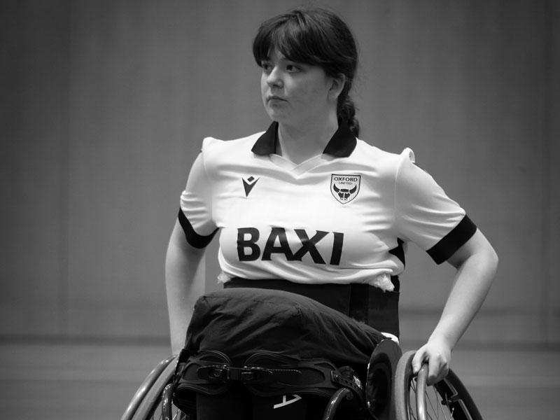 Oxford Kites Assistant Coach Linnet Drury sitting in her specialist basketball wheelchair