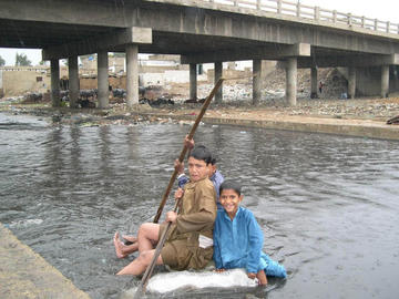 Still from Concrete Dreams children on a raft in Karachi