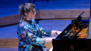 Ruth Minton playing the piano at the Tung Auditorium